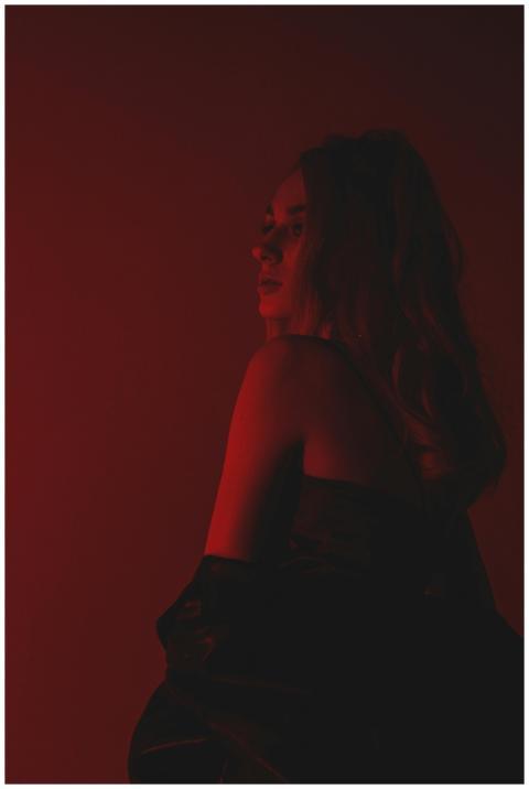 Artistic portrait with dramatic red lighting and s
