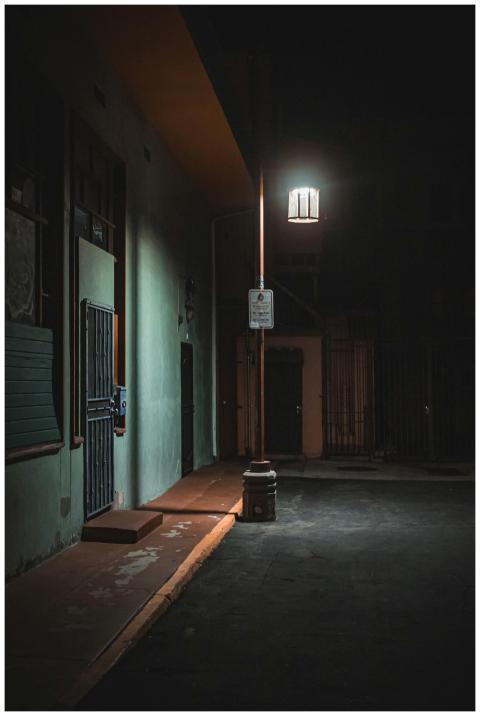 Dramatic night street scene with lamp lighting in