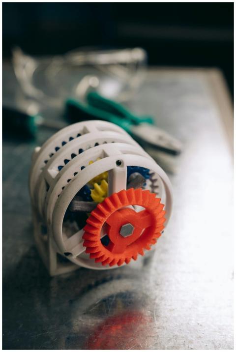 Close-up of colorful 3D printed gears on a workben