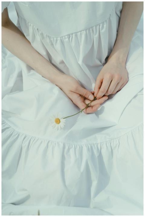 An elegant portrait of a woman in a white dress, g