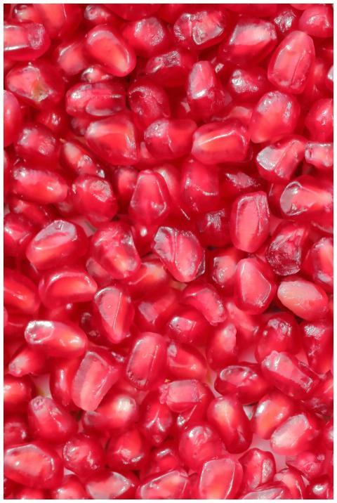 Close-up image of fresh red pomegranate seeds with