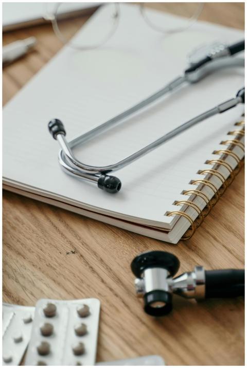 Close-up of a stethoscope placed over a notebook w