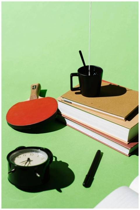 Artistic composition of books, coffee cup, clock,