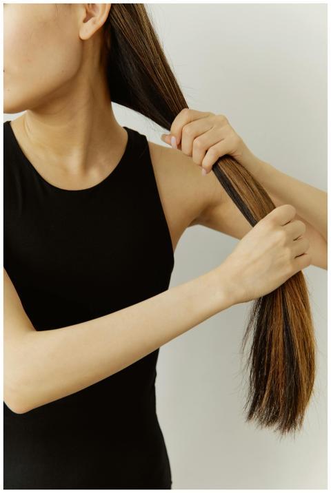Close-up of a woman brushing her long hair in a si