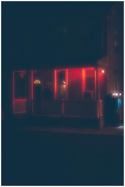 A mysterious night view of a building with red neo