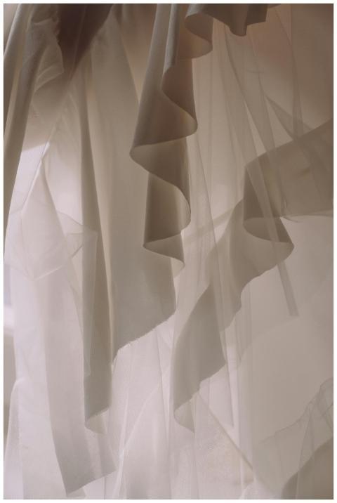 A delicate white fabric with soft, flowing layers,