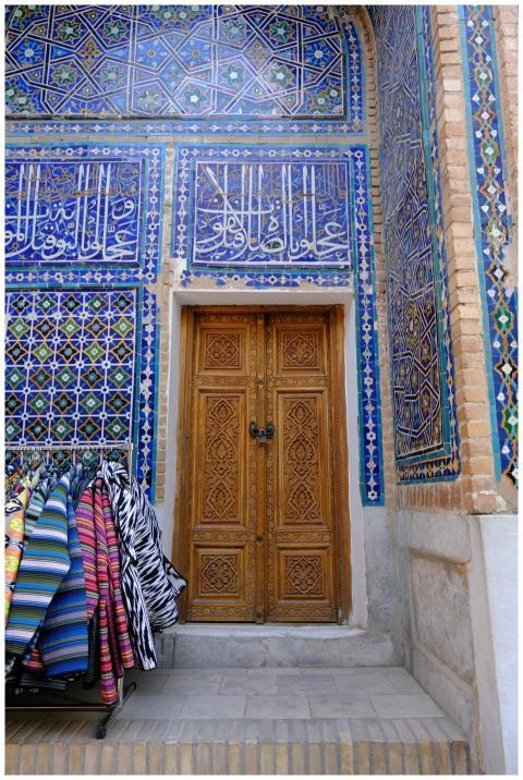 A traditional ornate wooden door set in a vibrant