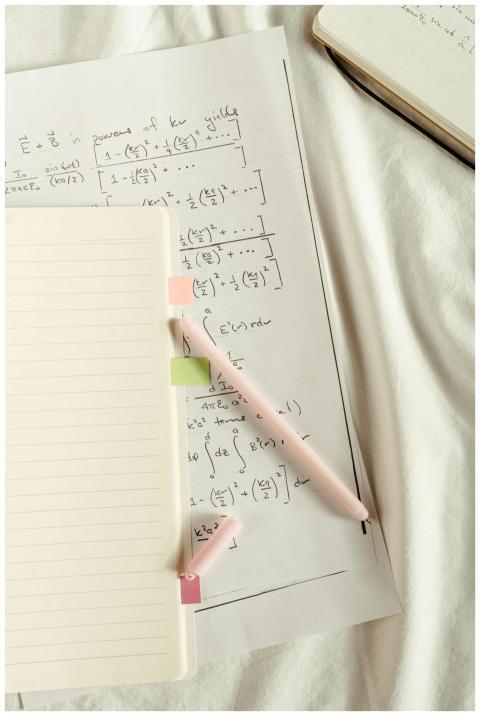 Flat lay of handwritten mathematical formulas and