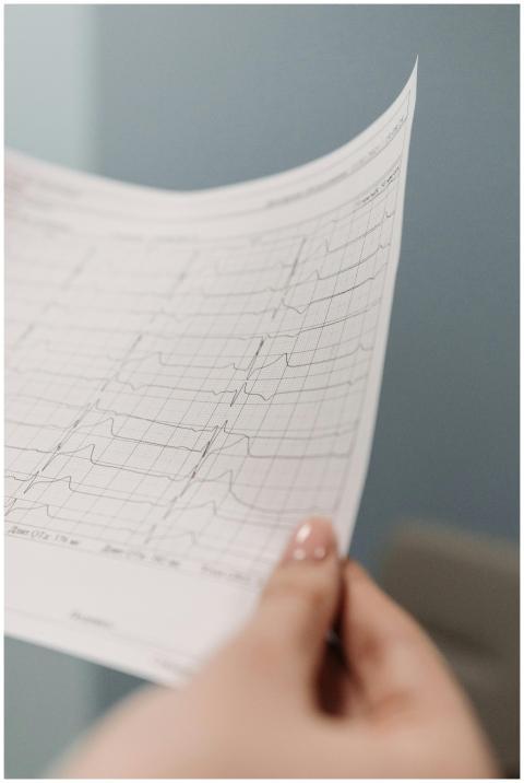 A detailed view of a person holding an electrocard