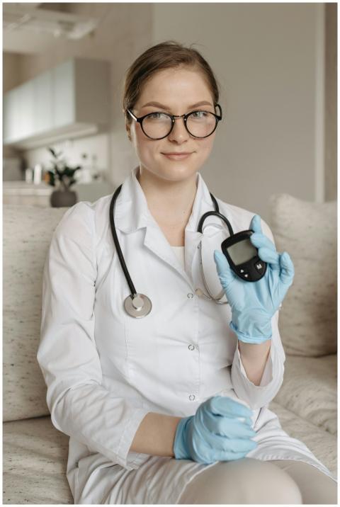 A female doctor with eyeglasses and gloves showcas