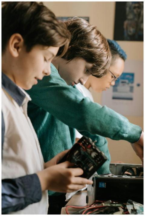 Young kids collaborating on a DIY computer project