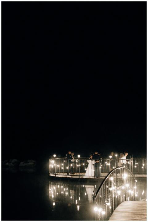 A romantic nighttime wedding with couples on a bea