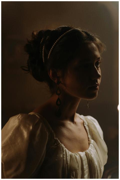 A captivating portrait of a woman in elegant, hist