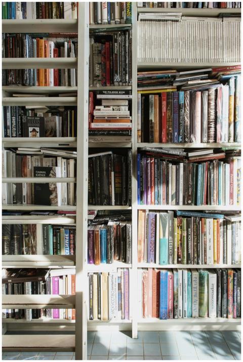 A bookshelf packed with a variety of colorful book