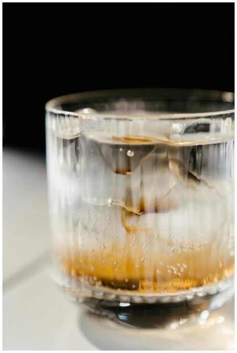 Close-up of a cold beverage with ice in a clear gl