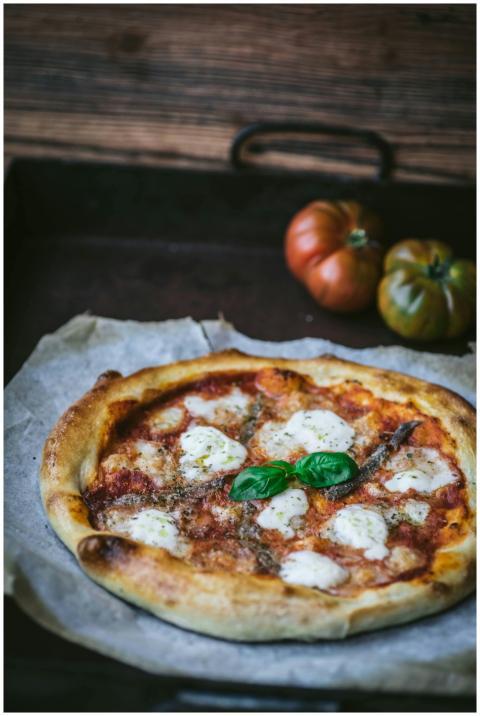 Artisan Margherita pizza topped with fresh basil,