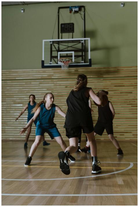 Dynamic indoor basketball game featuring female pl