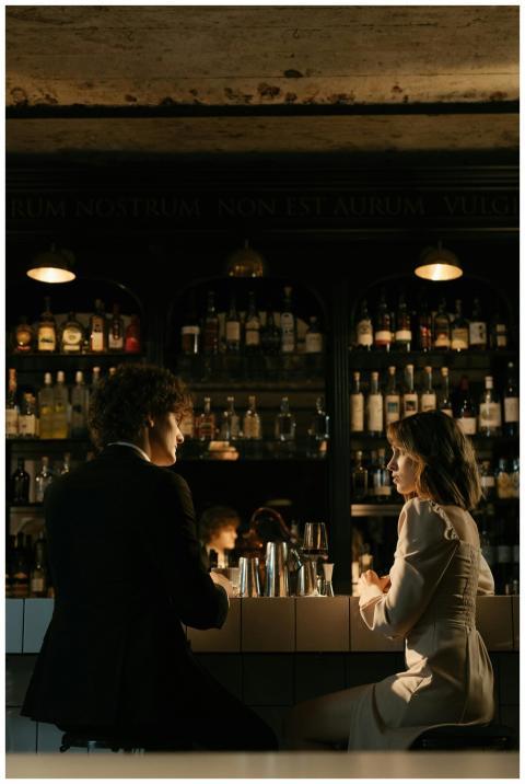 A couple enjoying a romantic evening at a bar, sur