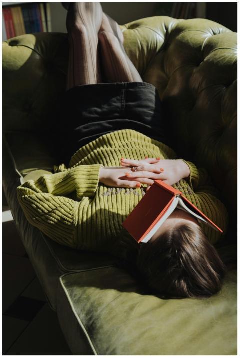 Young woman in green sweater and mini skirt relaxi