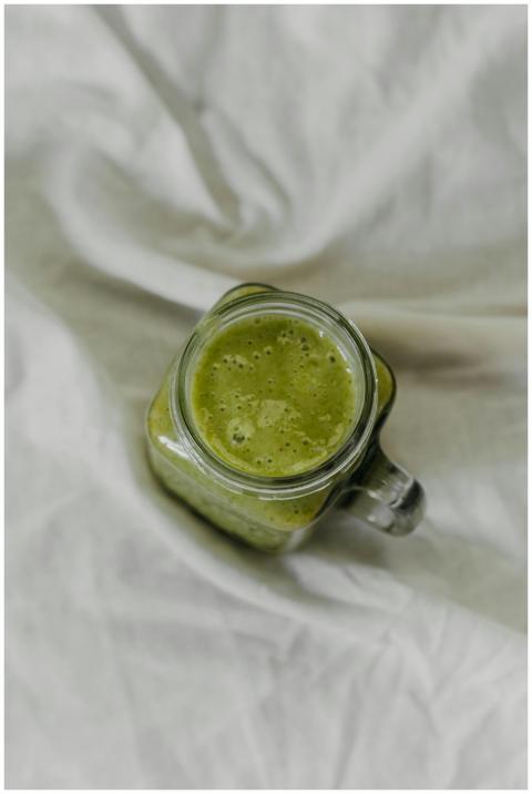 Top view of a nutritious green smoothie in a glass