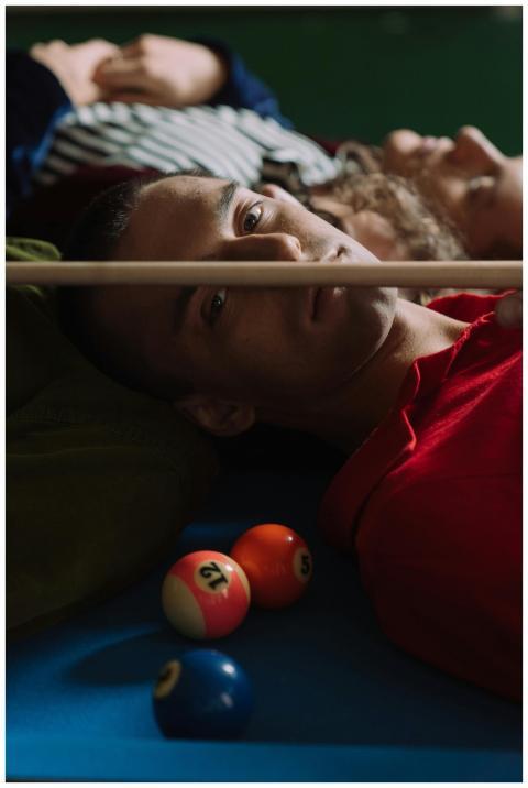 Artistic portrait of a man in a red shirt on a bil