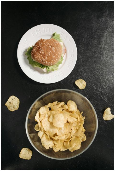 Appetizing burger and chips arrangement viewed fro