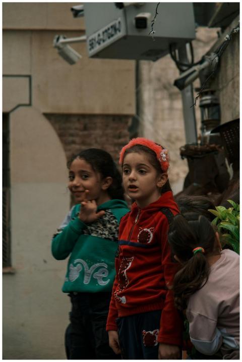 Group of children playing outdoors in an urban Mid