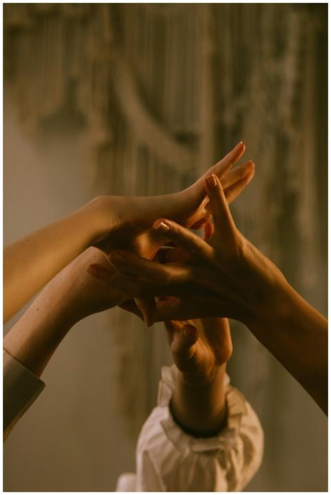 Close-up of hands gracefully intertwined, symboliz