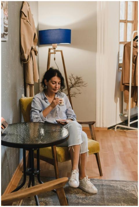 Woman relaxing with coffee in a stylish cafe inter