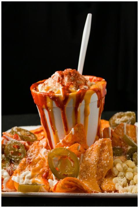 Close-up of loaded nachos topped with cheese, jala