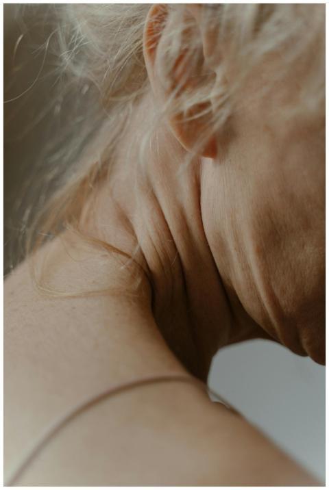 Detailed view of an elderly woman's neck, showcasi