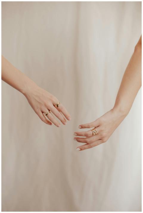 Artistic close-up of two elegant female hands wear