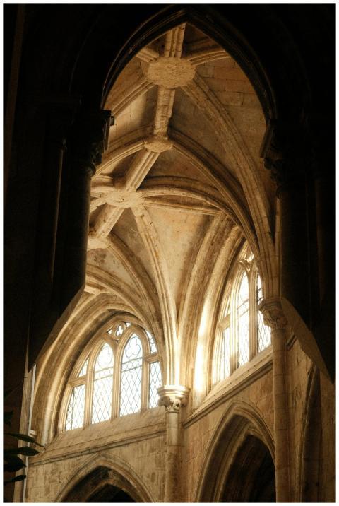 Sunlight streaming through Gothic cathedral arches