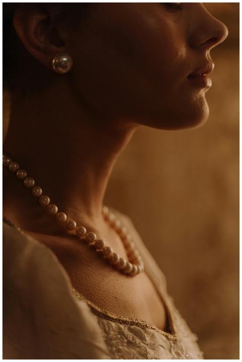 Close-up portrait of a woman wearing elegant pearl