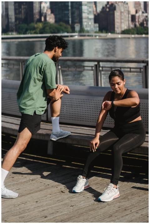 A couple pauses during their outdoor exercise, one