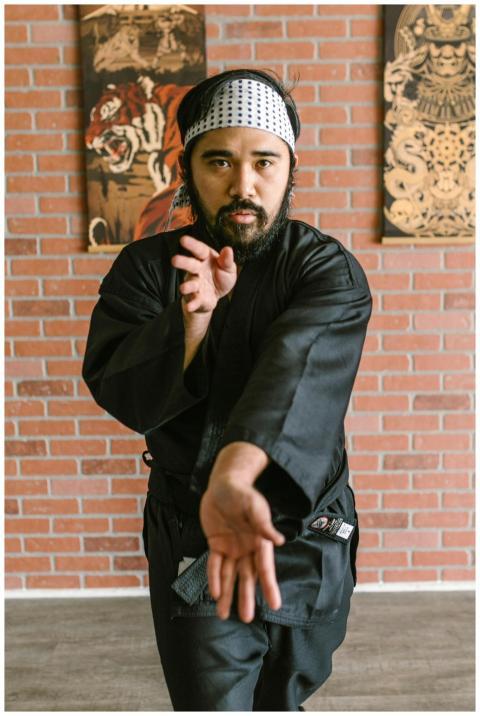 Man in black martial arts uniform practicing hand