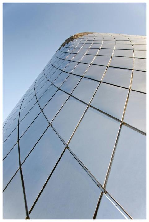 A modern skyscraper with reflective glass panels a