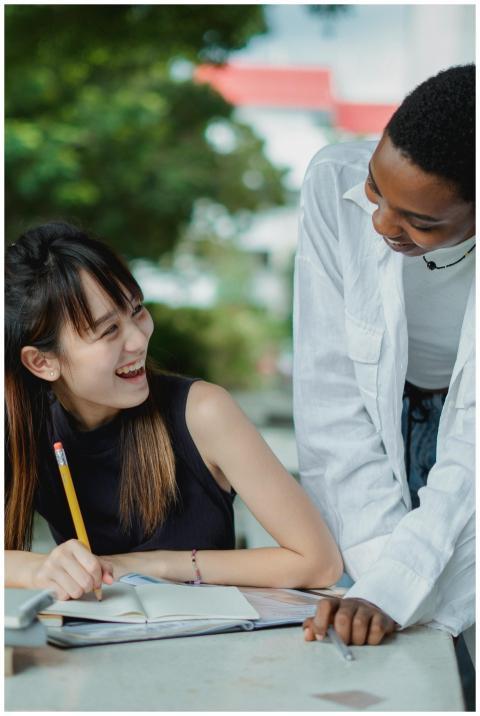 Happy young multiethnic ladies in casual outfit tu