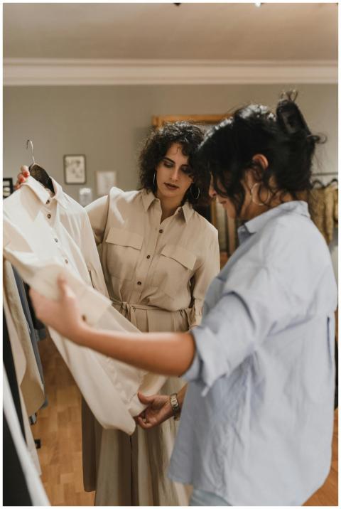 Two women shopping and discussing clothes in a sty