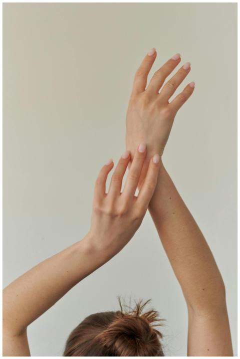 Close-up of a woman's hands elegantly posed, symbo