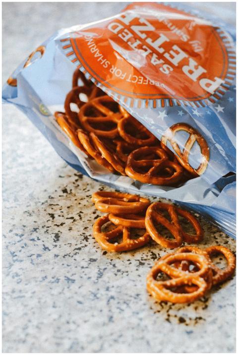 Crispy salted pretzels spilling from an open snack