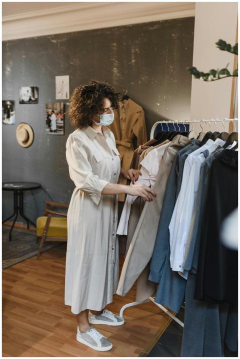 Woman browsing clothing in a store while wearing a