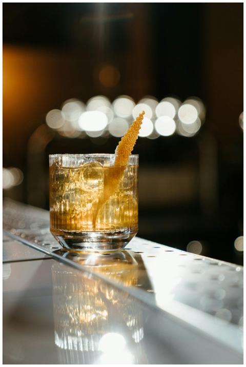 A sophisticated whiskey cocktail with citrus zest