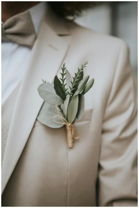 Close-up of a groom's boutonniere on a beige suit,