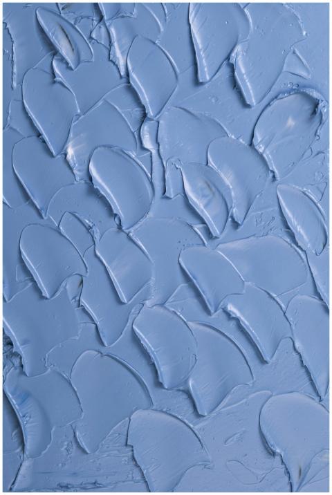 Close-up of blue textured paint creating an abstra