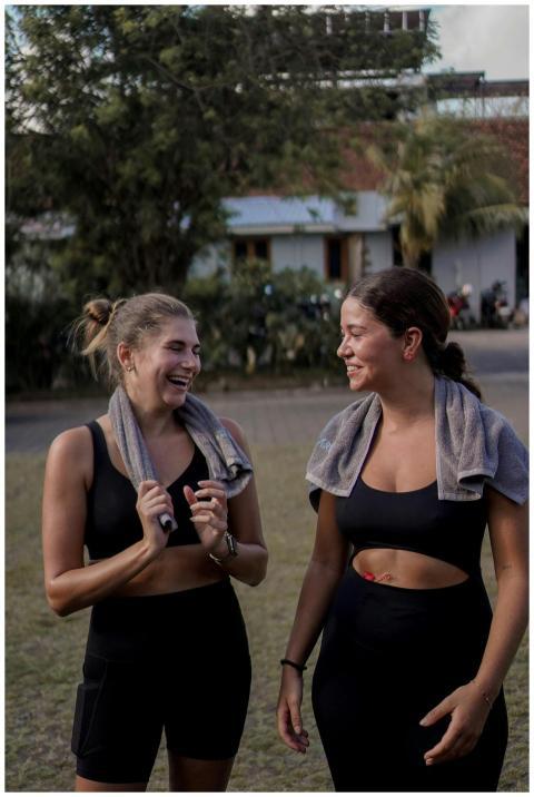 Two women relax and chat with towels around their