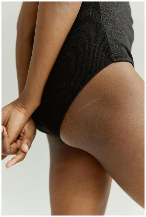 Close-up image of a woman's side profile in a blac