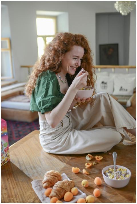 Redheaded woman happily enjoying a breakfast bowl