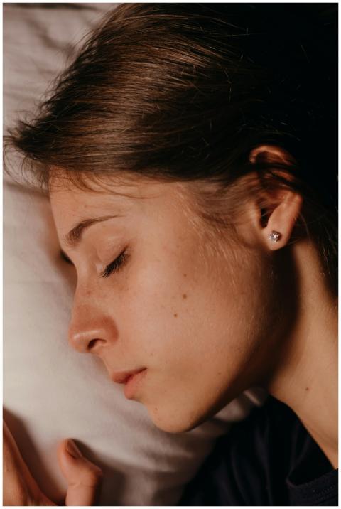 Close-up of a woman's peaceful sleeping face, high
