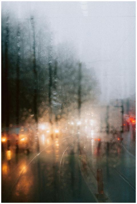 Blurred car headlights viewed through rain-streake